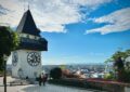 a clock tower on top of a building with a sky background
