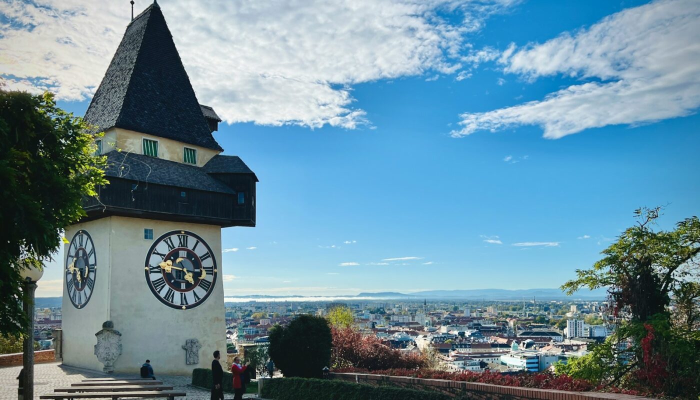 a clock tower on top of a building with a sky background