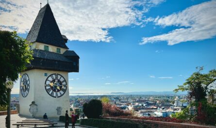 a clock tower on top of a building with a sky background