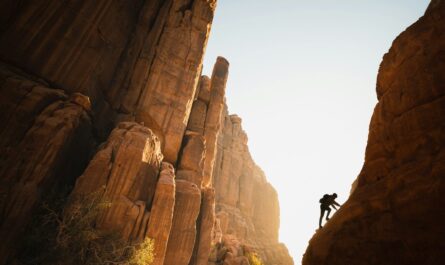 a man climbing up the side of a mountain